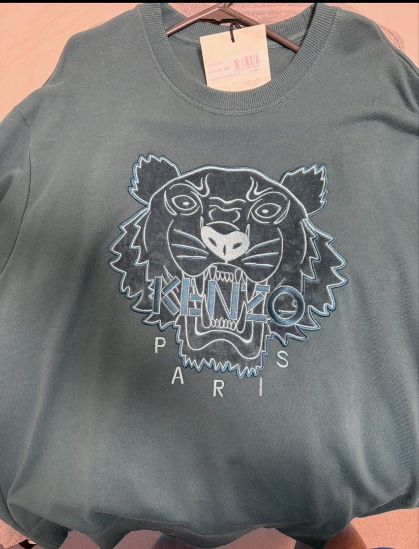 Kenzo Paris Tiger Sweatshirt (Category: Longsleeves) located in Manila. Submitted by adanielbm (Listing ID 1429803596, Image 2). Description: Kenzo Paris sweatshirt in teal color. Features the iconic tiger logo on the front. The sweatshirt has a crew neck and long sleeves. The tag is still attached. Made from a comfortable material, perfect for casual wear. A stylish addition to any wardrobe..