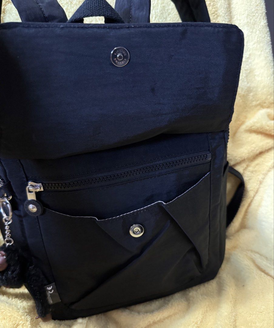 Kipling City Pack Mini Backpack (Category: Backpacks) located in Quezon City. Submitted by lailah00 (Listing ID 1429774549, Image 3). Description: Kipling City Pack Mini backpack is a stylish and compact bag. It features a main compartment with a zipper closure, a front pocket, and side pockets. The backpack includes adjustable shoulder straps and a top handle for versatile carrying options. It comes with the signature Kipling monkey keychain. Th