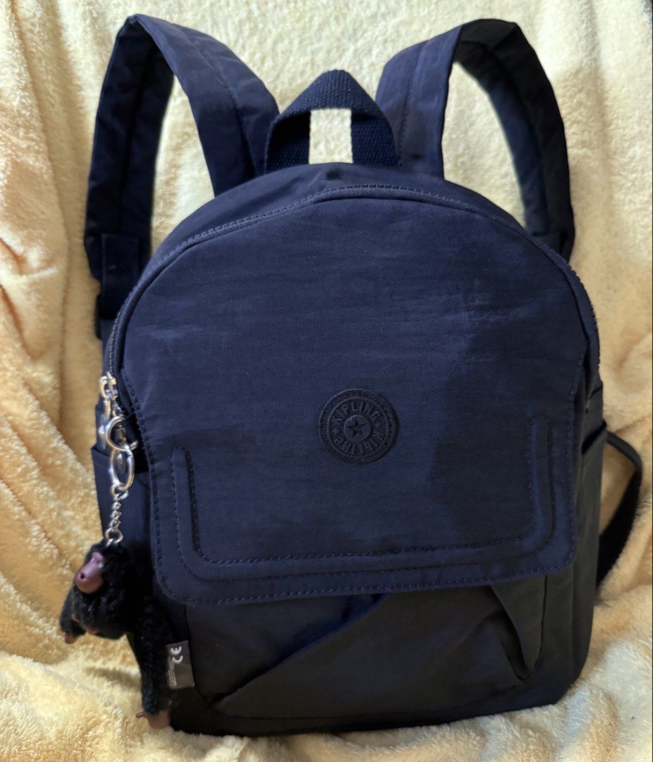 Kipling City Pack Mini Backpack (Category: Backpacks) located in Quezon City. Submitted by lailah00 (Listing ID 1429774549, Image 1). Description: Kipling City Pack Mini backpack is a stylish and compact bag. It features a main compartment with a zipper closure, a front pocket, and side pockets. The backpack includes adjustable shoulder straps and a top handle for versatile carrying options. It comes with the signature Kipling monkey keychain. Th