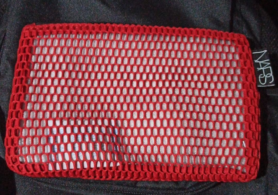 NARS Mesh Cosmetic Make up Pouch (Category: Makeup) located in Manila. Submitted by PureWonder_Shop (Listing ID 1416465343, Image 2). Description: 🇺🇸 NARS red mesh cosmetic bag - Features a zipper closure - Made of soft mesh material, not a nylon - Includes a small NARS label - Ideal for storing makeup and small items - Great for travel or everyday use 9" x 6" Can fit most iphones Color: Red 🧁.