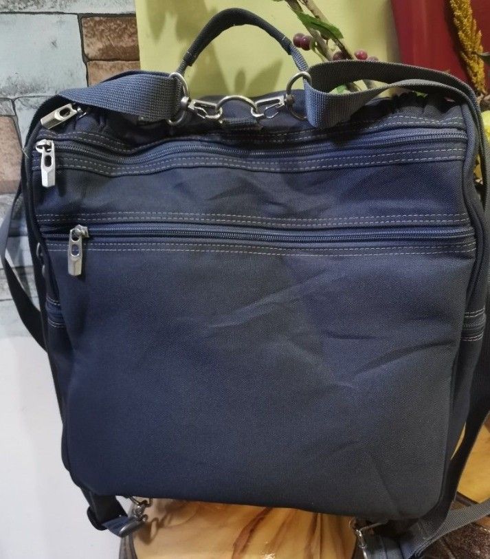 Ponopino Diaper Bag - Navy Blue (Category: Diaper Bags & Wetbags) located in Lipa City. Submitted by house.of.rosanoius. (Listing ID 1429704694, Image 3). Description: Navy blue diaper bag features multiple compartments and pockets for organized storage. It has a top handle and adjustable shoulder straps for versatile carrying options. The bag includes a front pocket and a main compartment with internal dividers. The Ponopino logo is visible on t