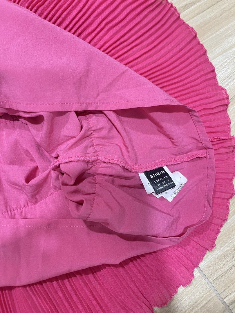 Pink Tiered Mini Dress (Category: Dresses) located in Manila. Submitted by cailleshope (Listing ID 1429719026, Image 3). Description: Vibrant pink mini dress features a tiered design with delicate spaghetti straps. The dress is made of pleated fabric, offering a flowy and flattering silhouette. It is a size M Perfect for a casual day out or a special occasion..