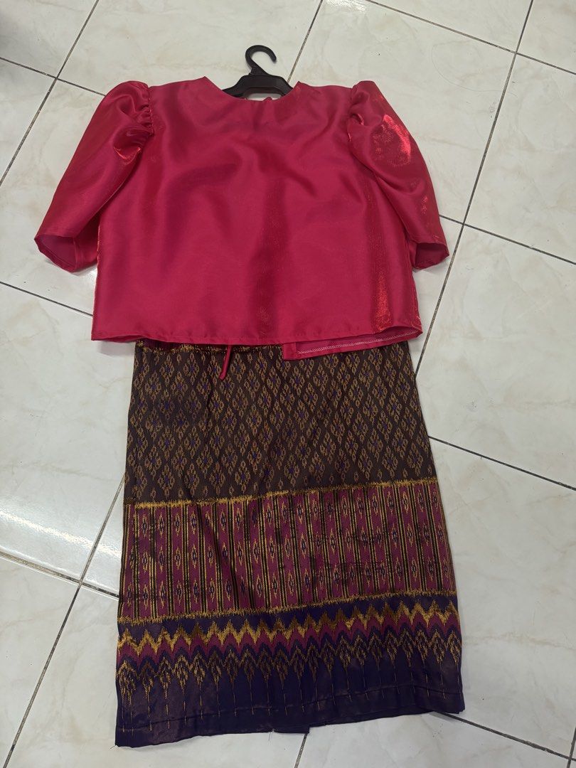 Pink Top and Patterned Skirt Set (Category: Sets or Coordinates) located in Quezon City. Submitted by silverls7 (Listing ID 1429730766, Image 3). Description: Set and top filipiniana set!! Set features a vibrant pink top with puff sleeves and a matching patterned skirt. The skirt showcases a detailed design with a combination of brown, gold, and purple hues. The top has a tie closure at the front. This set is perfect for special occasions or addi