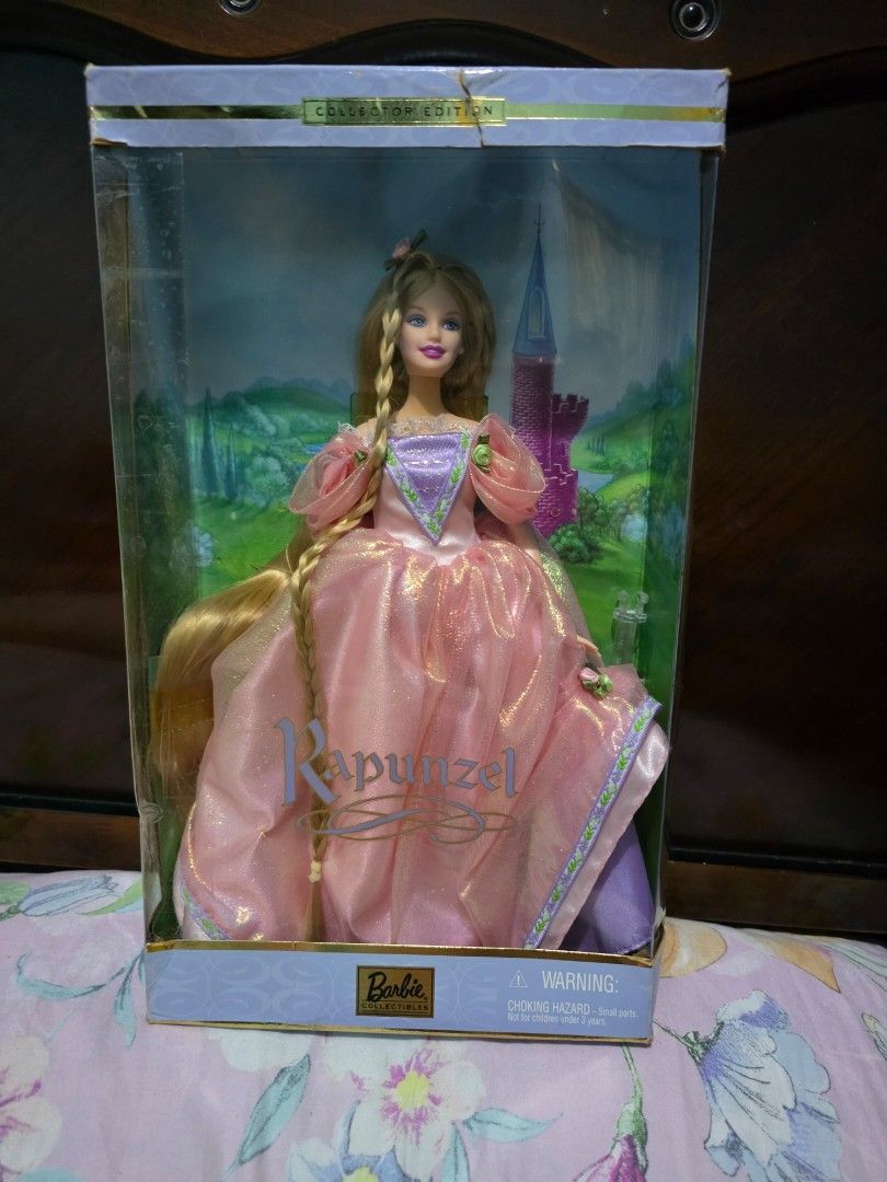 Rapunzel Collector Edition Barbie (Category: Figurines & Statues) located in Pasig City. Submitted by dolliesandpastels (Listing ID 1429835479, Image 1). Description: NRFB Box is not in the best condition (tear in front, creases, minimal scratches in the acetate plastic).