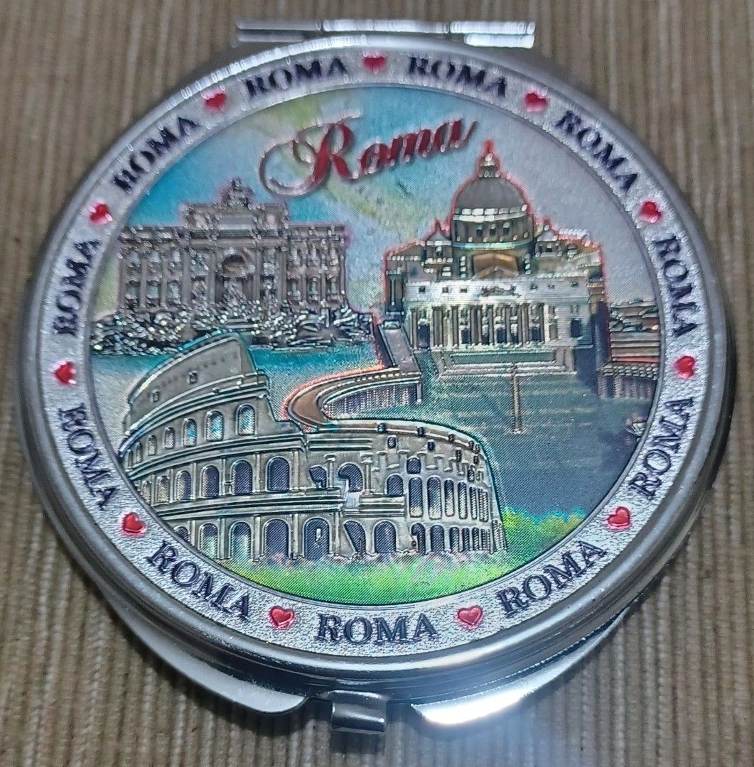 Rome Italy Souvenir Compact Mirror ✨ (Category: Mirrors) located in Quezon City. Submitted by wjmae (Listing ID 1429801437, Image 1). Description: Bring home a piece of the Eternal City! This beautiful double-sided compact mirror features iconic Roman landmarks – the Colosseum, St. Peter’s Basilica, and classical architecture – with vibrant, detailed artwork. ✅ Features: - Double-sided (standard + magnifying mirror) ​ - Diameter: ~6.5cm / 2.5 inc