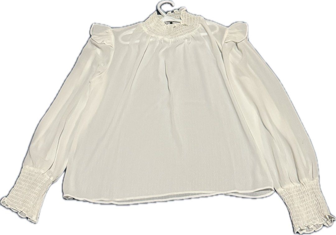 Sheer white high-neck blouse from Trendyol (Category: Blouses) located in Quezon City. Submitted by ayahko (Listing ID 1429807483, Image 2). Description: Trendyol sheer white high neck blouse with smocked cuffs, size 40 (fits medium to large frames) Great with a tube or tank underneath It's giving BTS/Jimin—cool piece for styling for the Arirang concerts!.