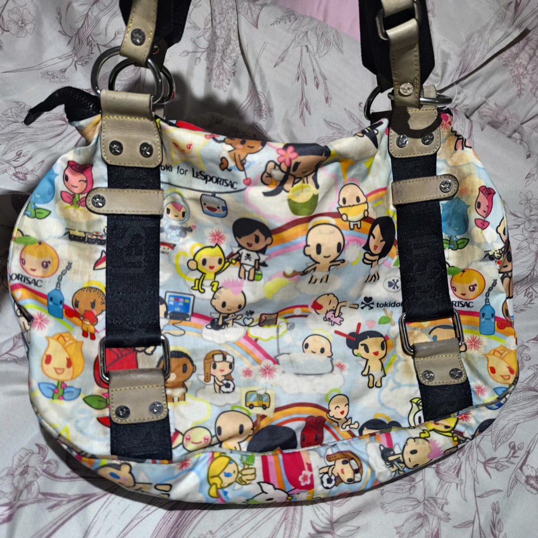 Tokidoki for LeSportsac Handbag (Category: Shoulder Bags) located in Manila. Submitted by yui021 (Listing ID 1429670278, Image 2). Description: - LeSportsac shoulder bag features a colorful Tokidoki print. - I used to use this back in highschool, and I wasn't very careful with it. Bag has a lot of discolorations outside and inside (pen marks). Flaws are shown in the pictures, but can provide more photos. - This is still amazing quality, it's just