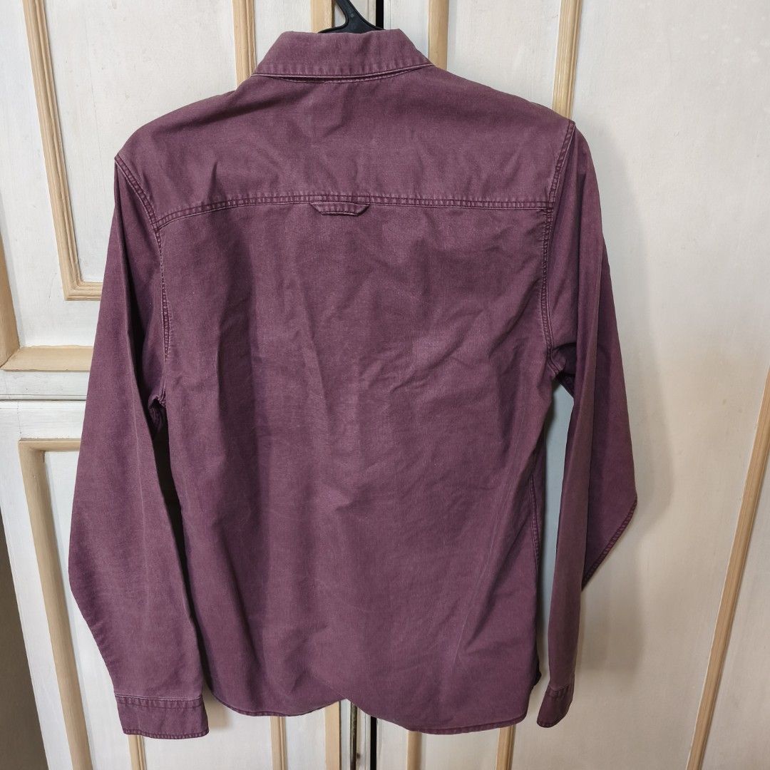 Topman Maroon Long Sleeve Shirt (Category: Tshirts & Polo Shirts ) located in Mandaluyong City. Submitted by giaquino (Listing ID 1429736602, Image 2). Description: Maroon long sleeve shirt from Topman. Features a button-down front and a single pocket with a patterned design. The shirt has a classic collar and buttoned cuffs. The back of the shirt is plain with a yoke detail. Made of a solid color fabric..