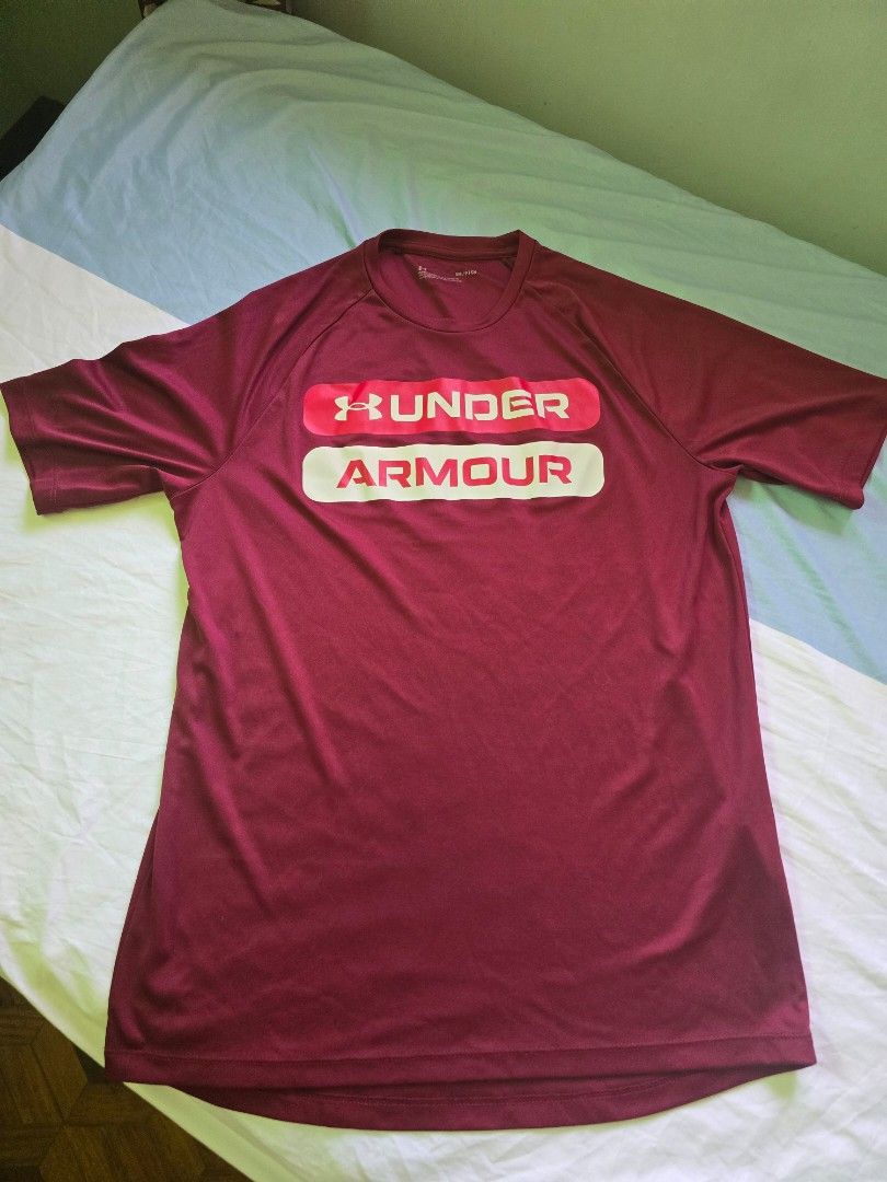 Under Armour Loose Fit T-Shirt (Category: Tshirts & Polo Shirts ) located in Quezon City. Submitted by jb0516 (Listing ID 1429692976, Image 1). Description: Maroon Under Armour t-shirt. Features the Under Armour logo on the front. The shirt is size SM/CH. Made in Honduras. The shirt has short sleeves and a crew neck..