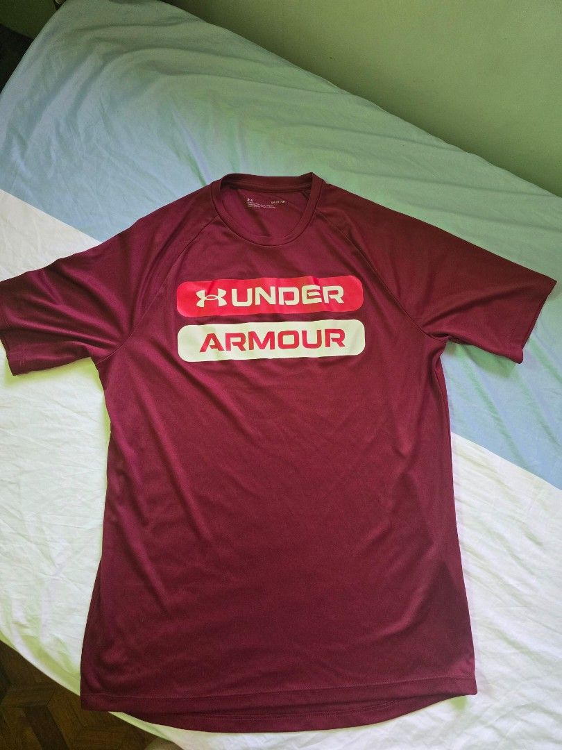 Under Armour Loose Fit T-Shirt (Category: Tshirts & Polo Shirts ) located in Quezon City. Submitted by jb0516 (Listing ID 1429692976, Image 2). Description: Maroon Under Armour t-shirt. Features the Under Armour logo on the front. The shirt is size SM/CH. Made in Honduras. The shirt has short sleeves and a crew neck..