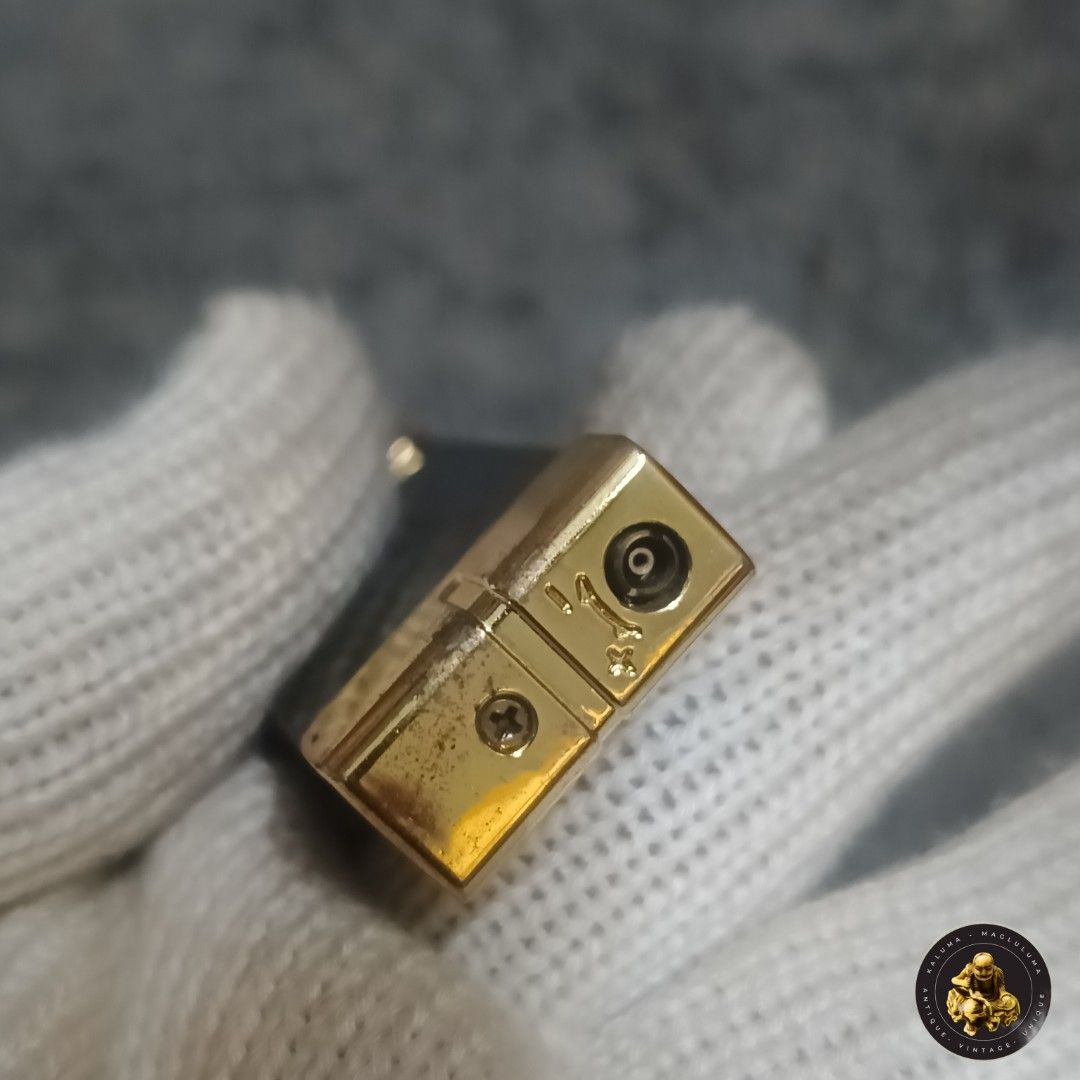 Vintage Metal Lighter (Category: Vintage Collectibles) located in Meycauayan. Submitted by ka_luma (Listing ID 1429687254, Image 3). Description: Vintage lighter features a rectangular design with a metal body and gold-colored accents. It has a hinged top and a visible screw detail. It is a compact size, suitable for carrying in a pocket or bag..