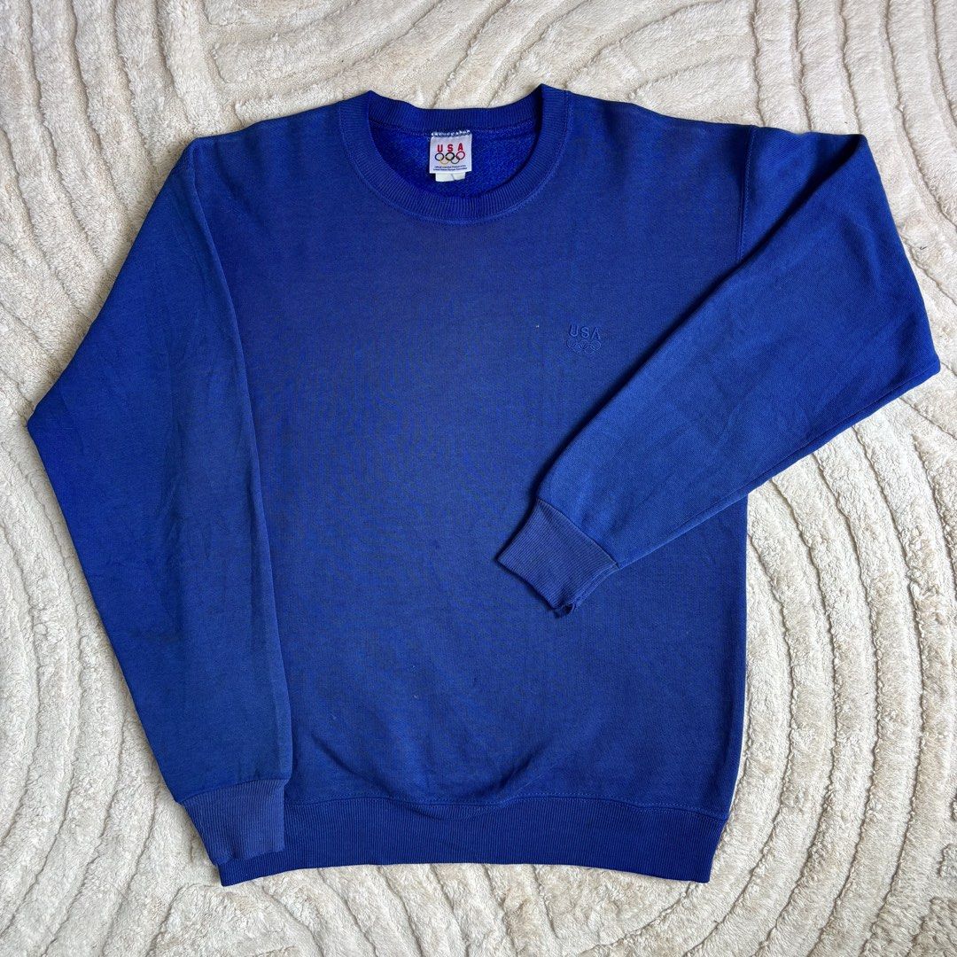 Vintage USA Olympic Sweatshirt (Category: Coats, Jackets and Outerwear) located in Quezon City. Submitted by grailph (Listing ID 1429724024, Image 2). Description: 🌐 Vintage USA Olympics Pullover Sweatshirt Fits large 20.5”x27.5” Dimensions Color rate 8/10 Issue Frayings, Stains, Fade Frayings and stains adds personality to this piece of history Vintage blue sweatshirt featuring the USA Olympic logo and branding. It has a crew neck and long slee