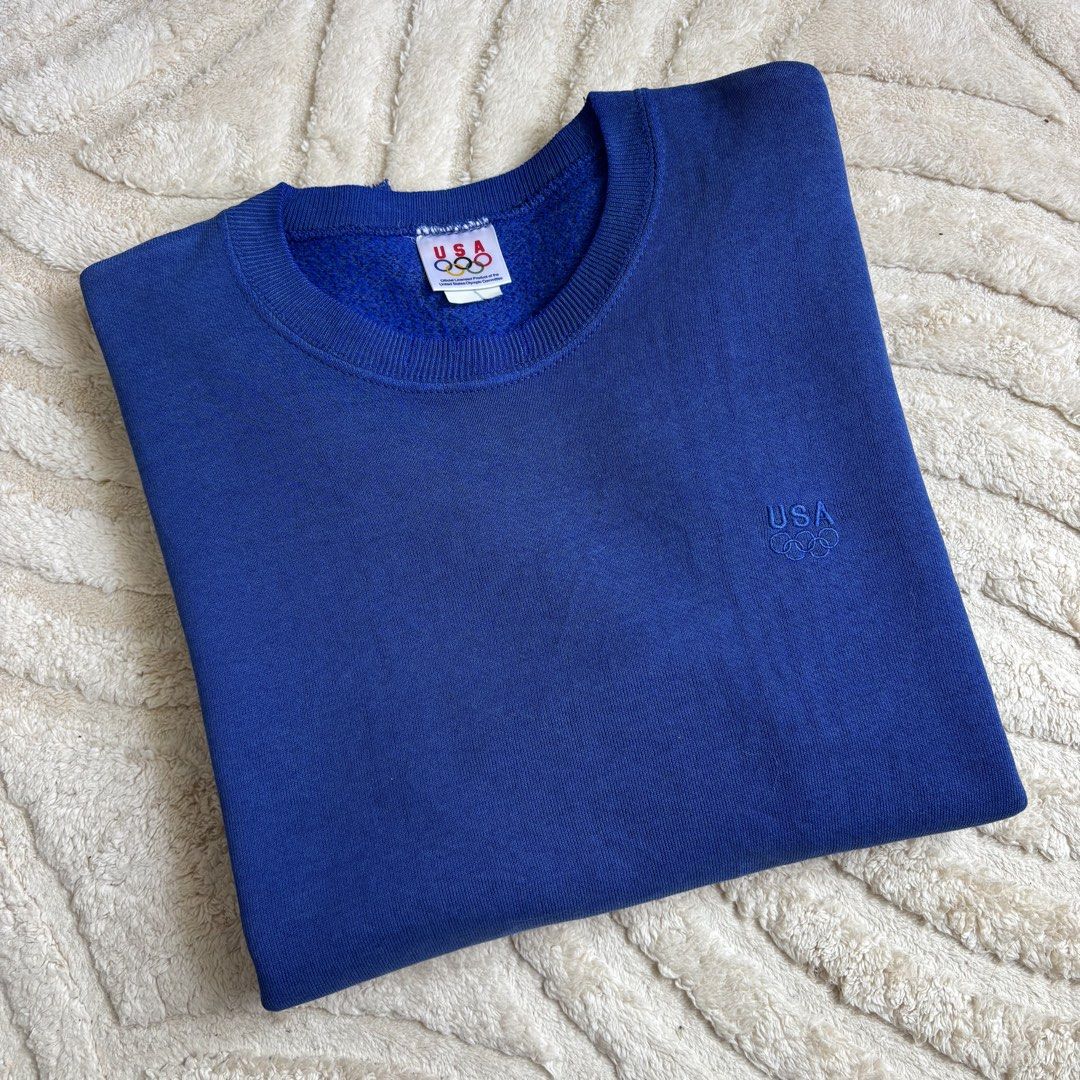Vintage USA Olympic Sweatshirt (Category: Coats, Jackets and Outerwear) located in Quezon City. Submitted by grailph (Listing ID 1429724024, Image 1). Description: 🌐 Vintage USA Olympics Pullover Sweatshirt Fits large 20.5”x27.5” Dimensions Color rate 8/10 Issue Frayings, Stains, Fade Frayings and stains adds personality to this piece of history Vintage blue sweatshirt featuring the USA Olympic logo and branding. It has a crew neck and long slee