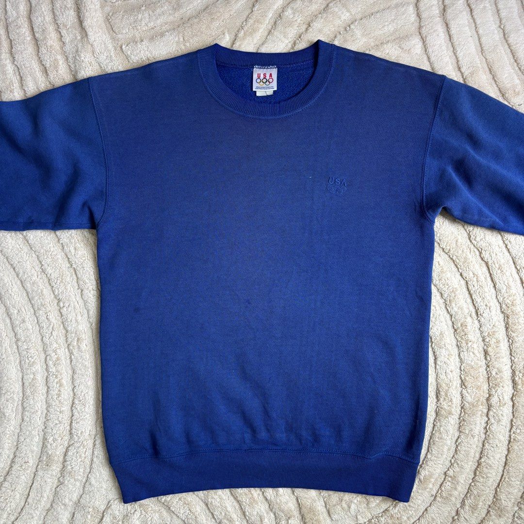 Vintage USA Olympic Sweatshirt (Category: Coats, Jackets and Outerwear) located in Quezon City. Submitted by grailph (Listing ID 1429724024, Image 3). Description: 🌐 Vintage USA Olympics Pullover Sweatshirt Fits large 20.5”x27.5” Dimensions Color rate 8/10 Issue Frayings, Stains, Fade Frayings and stains adds personality to this piece of history Vintage blue sweatshirt featuring the USA Olympic logo and branding. It has a crew neck and long slee