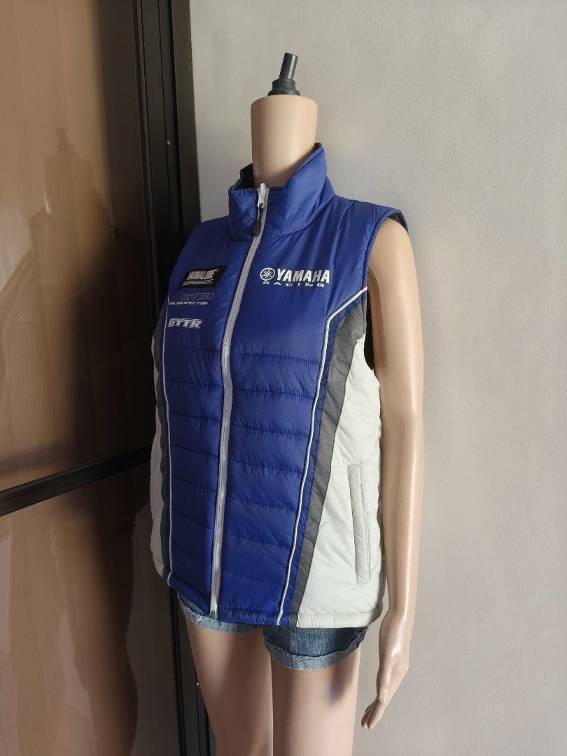 Yamaha Racing Reversible Vest (Category: Vests) located in Siniloan. Submitted by wingedwardrobe (Listing ID 1428695433, Image 3). Description: 21x24 Size L Excellent condition, no issue Reversible vest featuring a black side and a blue Yamaha Racing design. It has a full-length zipper and a stand-up collar. The blue side has Yamaha Racing branding on the chest. It is sleeveless and suitable for layering. 𝓐𝓵𝓵 𝓲𝓽𝓮𝓶𝓼 𝓪𝓻𝓮 𝓾𝓷𝔀𝓪𝓼𝓱𝓮𝓭
