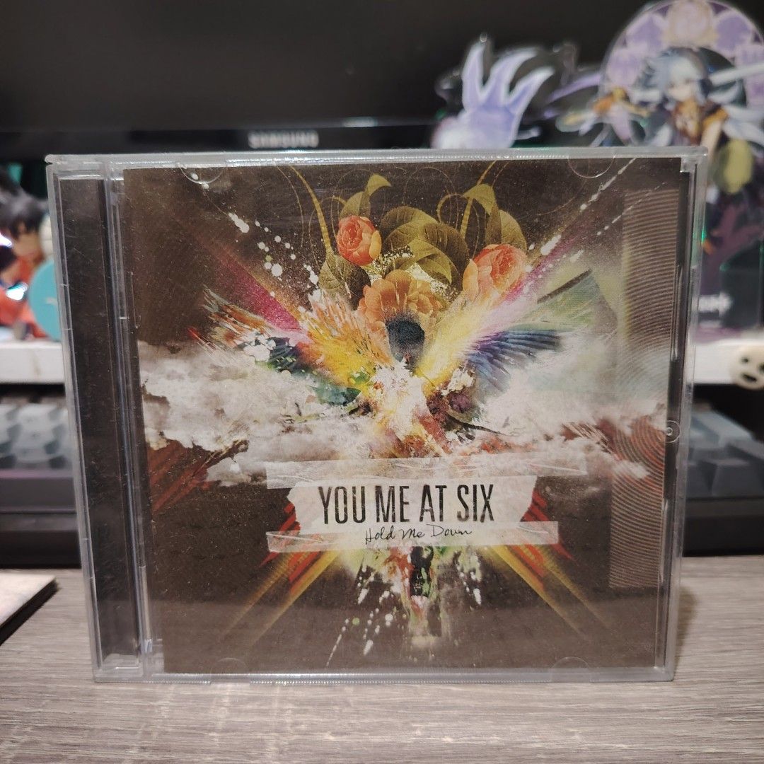 You Me At Six - Hold Me Down CD (Category: CDs & DVDs) located in Bulacan. Submitted by qilyuartstudio (Listing ID 1429802399, Image 1). Description: Original CD of You Me At Six's album, Hold Me Down. The CD case is visible in the image. The album cover features a colorful design with the band's name and album title. A great addition for any music collector or fan of the band..