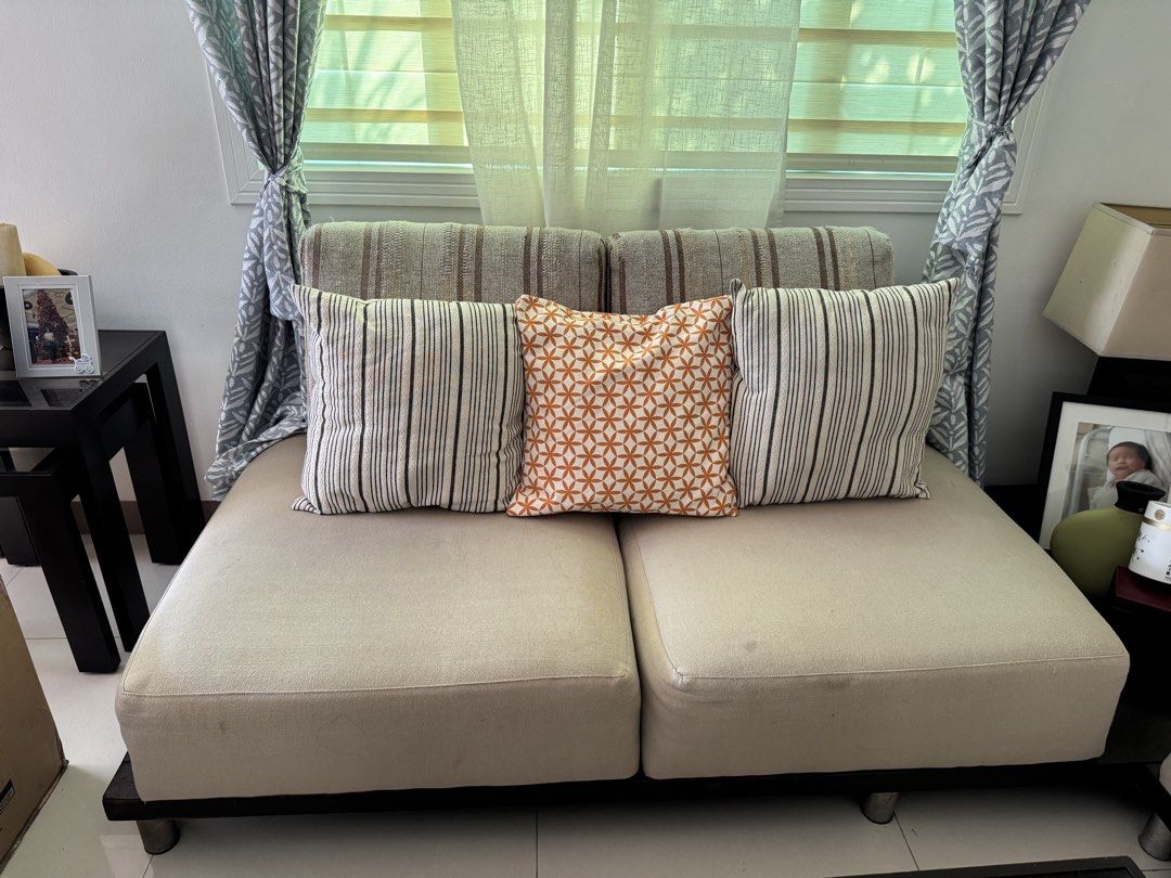 4- Seater Sofa with Pillows (Category: Sofas) located in Rizal. Submitted by christine122592 (Listing ID 1433341651, Image 1). Description: - 4 seater sofa - Neutral beige fabric - Striped backrest design - Dark wooden base with metal legs - Approximately 1.52 meters in length - Perfect for any living room.
