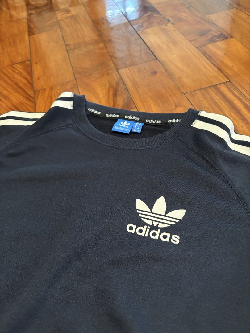 Adidas 3-Stripes Crew Sweatshirt - Navy Blue (Category: Coats, Jackets and Outerwear) located in Pasig City. Submitted by mvsdb (Listing ID 1433302983, Image 3). Description: ORIGINAL AUTHENTIC - Adidas crew sweatshirt - Navy blue with white stripes - Adidas logo on chest - Size M - Adidas logo on neckline - Comfortable fabric.