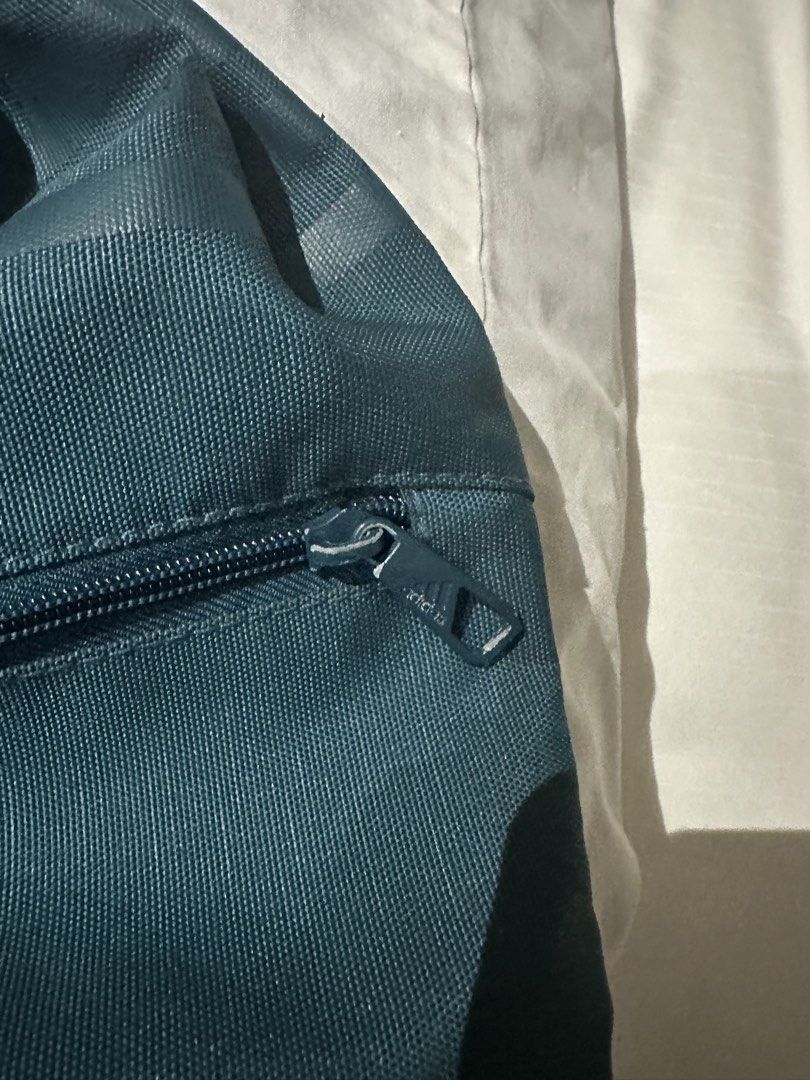 Adidas Drawstring Bag (Category: Backpacks) located in Manila. Submitted by qualitypreluvd (Listing ID 1433342644, Image 2). Description: - Adidas teal drawstring bag - Gold Adidas logo - Zippered front pocket - Drawstring closure - Small hanging loop - Adidas logo on zipper - Ideal for gym clothes and essentials.