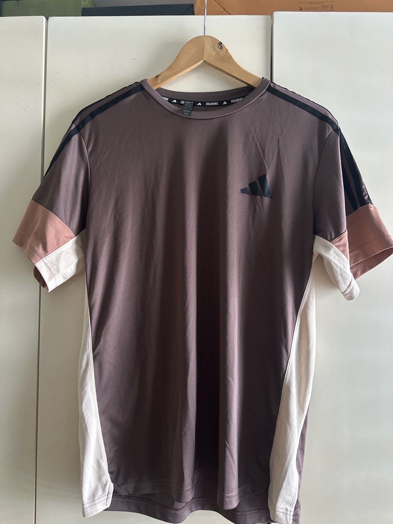 Adidas Training T-Shirt XL (Category: Activewear) located in Taguig. Submitted by jsrbrandeditems (Listing ID 1433223669, Image 1). Description: - Adidas training t-shirt - Brown with black shoulder stripes - Color-blocked sleeves (white and pink) - Small Adidas logo on chest - Size: XL - Made in Myanmar.