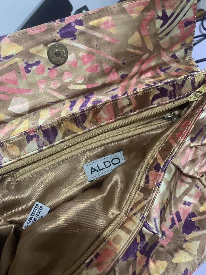 Aldo Clutch Bag with Geometric Print (Category: Clutches) located in Quezon City. Submitted by kitkatvergz (Listing ID 1433378711, Image 1). Description: - Aldo clutch bag - Unique geometric print (brown, pink, purple) - Fold-over flap with magnetic closure - Interior: zippered pocket, gold lining - Material: Polyester.