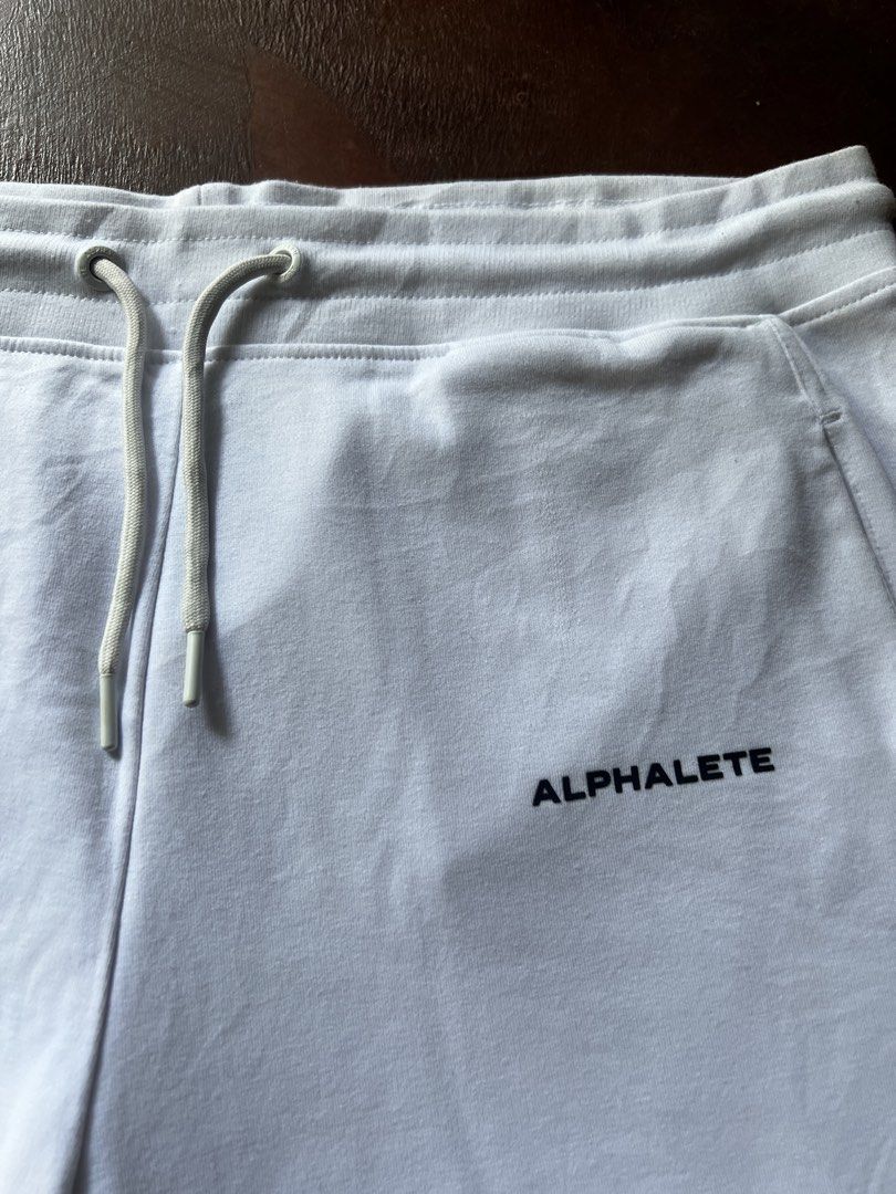 Alphalete White Shorts - Size L (Category: Activewear) located in Nabua. Submitted by gandathriftstore (Listing ID 1433215310, Image 2). Description: - White Alphalete shorts - Size: L - Features: - Drawstring waist - Alphalete logo - Two back pockets - Material: Cotton-elastane blend - Care: Machine washable.