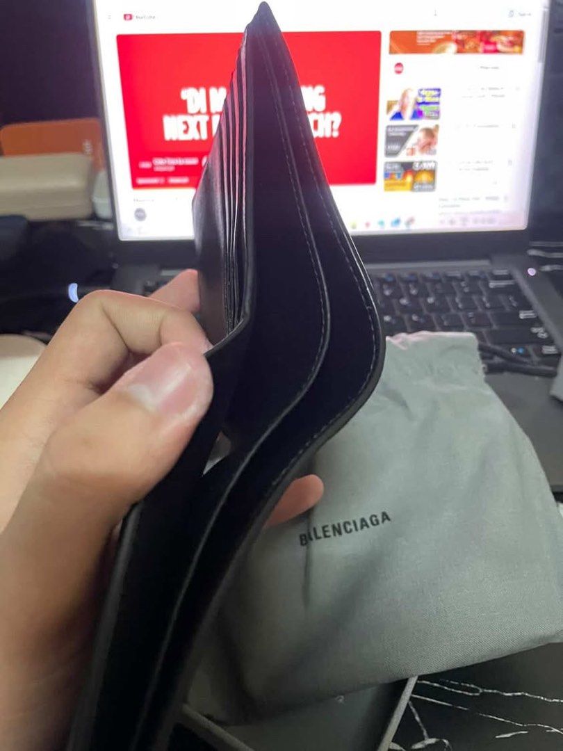 Balenciaga Black Leather Wallet (Category: Luxury Bags & Wallets) located in Manila. Submitted by mzzzxxxx.41 (Listing ID 1433264137, Image 3). Description: - Authentic Balenciaga wallet - Black leather - Balenciaga logo on front - Includes original box, dust bag, and care cards - Multiple card slots and bill compartments - Unused condition.