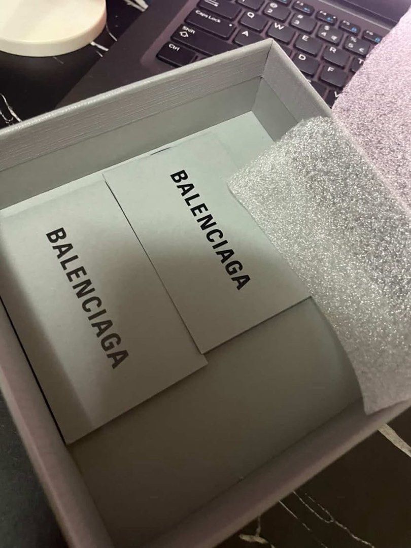 Balenciaga Leather Wallet (Category: Luxury Bags & Wallets) located in Manila. Submitted by mzzzxxxx.41 (Listing ID 1433304688, Image 3). Description: - Authentic Balenciaga wallet - Color: Black - Includes: Dust bag, box, and authenticity cards - Features: - Multiple card slots - Bill compartment - Balenciaga logo visible - Comes with original packaging.