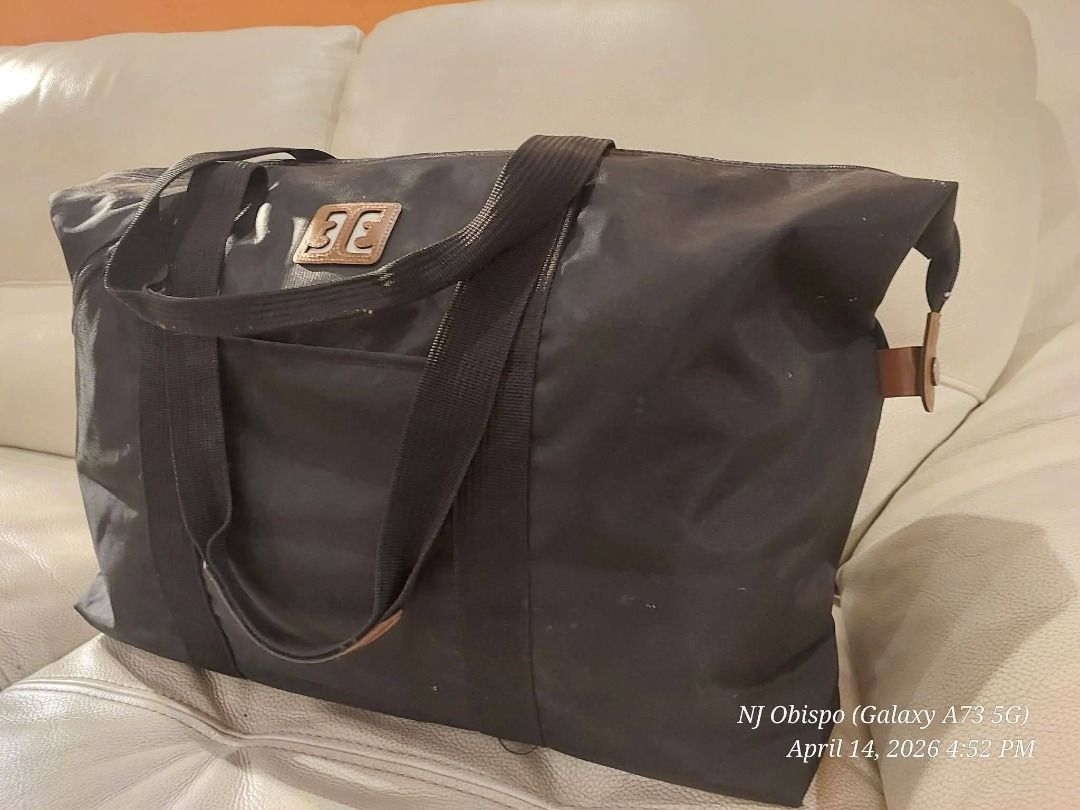 Black Tote Bag with Brown Accents (Category: Tote Bags) located in Taguig. Submitted by jaybrandedstore (Listing ID 1433249888, Image 3). Description: - Black rectangular tote bag - Zipper pocket on the side - Front logo detail - Dual handles with brown accents - Made of durable material, water resistant - 500 only.