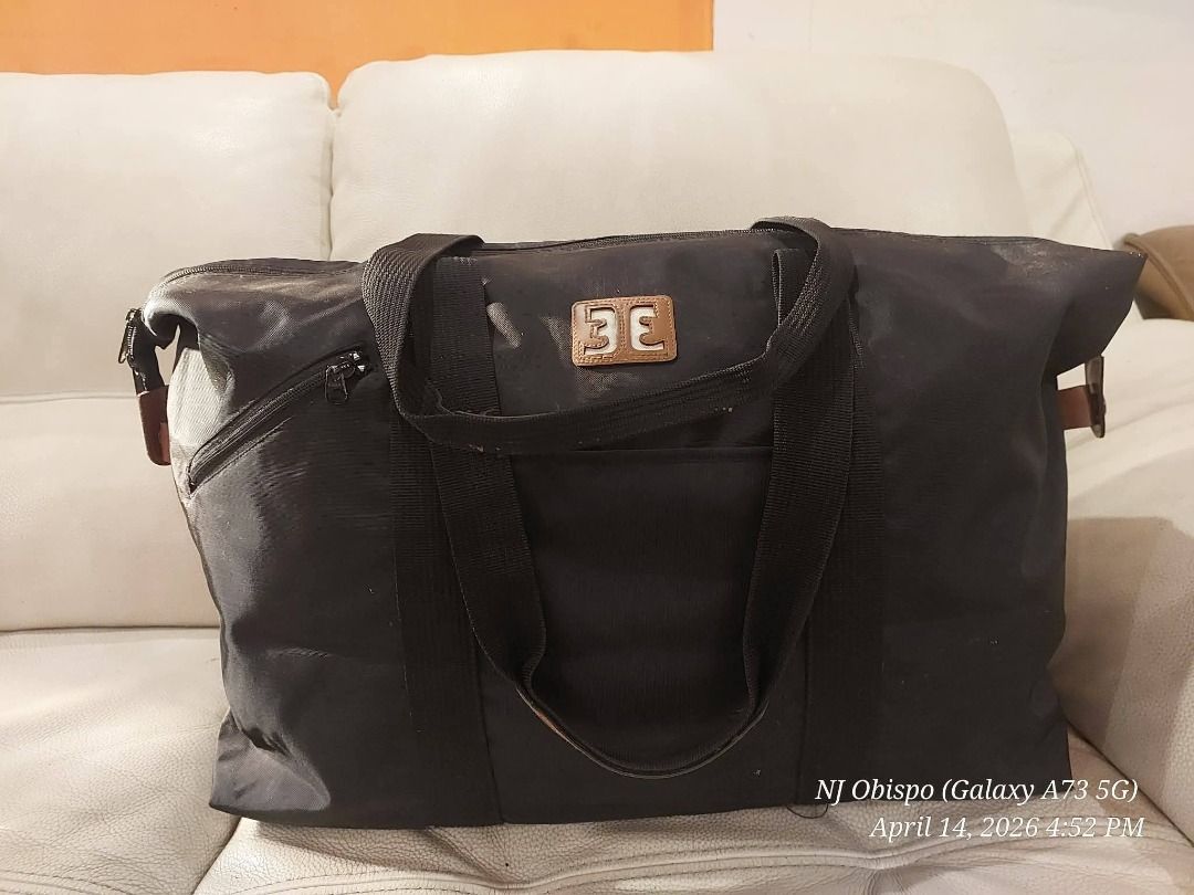Black Tote Bag with Brown Accents (Category: Tote Bags) located in Taguig. Submitted by jaybrandedstore (Listing ID 1433249888, Image 1). Description: - Black rectangular tote bag - Zipper pocket on the side - Front logo detail - Dual handles with brown accents - Made of durable material, water resistant - 500 only.
