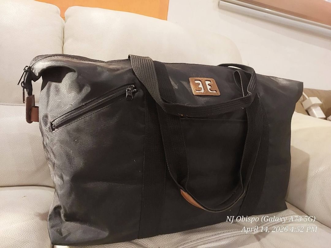 Black Tote Bag with Brown Accents (Category: Tote Bags) located in Taguig. Submitted by jaybrandedstore (Listing ID 1433249888, Image 2). Description: - Black rectangular tote bag - Zipper pocket on the side - Front logo detail - Dual handles with brown accents - Made of durable material, water resistant - 500 only.