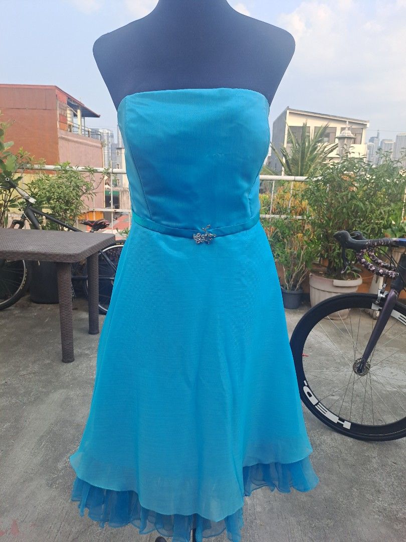 Blue Strapless Cocktail Dress (Category: Dresses) located in Manila. Submitted by maggie54145 (Listing ID 1433297566, Image 1). Description: - 47 cm / 18 inches bust size - 39 inches length - 32-36 inches waistline - Elegant blue strapless cocktail dress - Fitted bodice with waist embellishment - Layered skirt with ruffled hem - Includes a matching shawl - Perfect for special occasions.