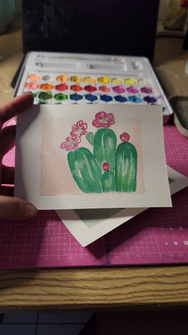 Cactus Watercolor Painting (Category: Art & Prints) located in Cavite. Submitted by joycreates (Listing ID 1433309798, Image 2). Description: - Hand-painted watercolor painting - Features a cactus with pink flowers - frame not included - Small size, perfect for any space - Adds a touch of nature.
