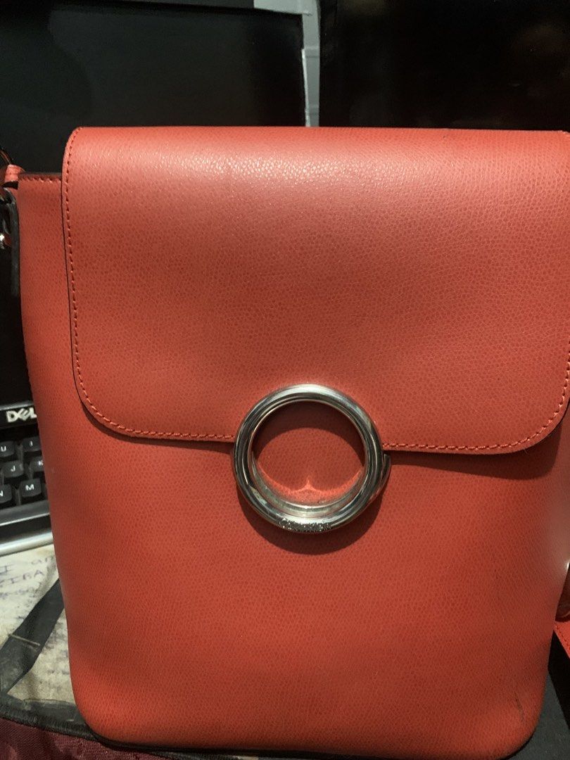 Calvin Klein Red Handbag/backpack (Category: Luxury Bags & Wallets) located in Quezon City. Submitted by lelouchonash (Listing ID 1433222045, Image 1). Description: - original Calvin Klein red handbag - Unique silver ring closure - Convertible design: backpack straps included - Detachable shoulder strap - Spacious interior - Durable material - Perfect for everyday or special occasions.