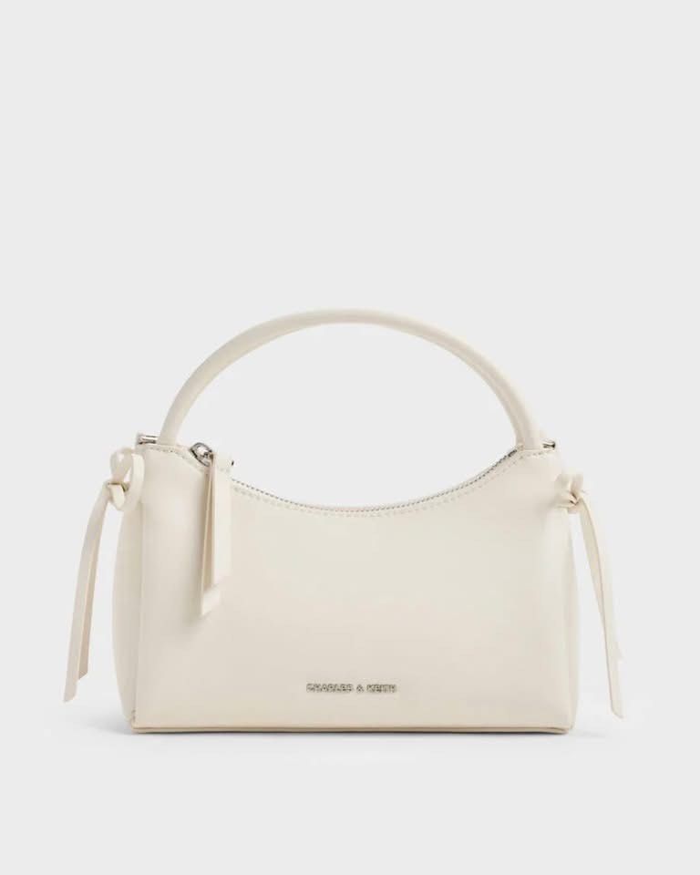 Charles & Keith Hazel Bow TopHandle Bag (Category: Shoulder Bags) located in Pasig City. Submitted by ff.ph (Listing ID 1433391747, Image 2). Description: Top Handle Bag Pastel colors Color Available Mint Green - Soft Pink - Cream With Detachable and Adjustable Strap Material Calf PU Size 21x9x13 cm Zip closure With Echodustbag and serial number Add paperbag plus 80 .