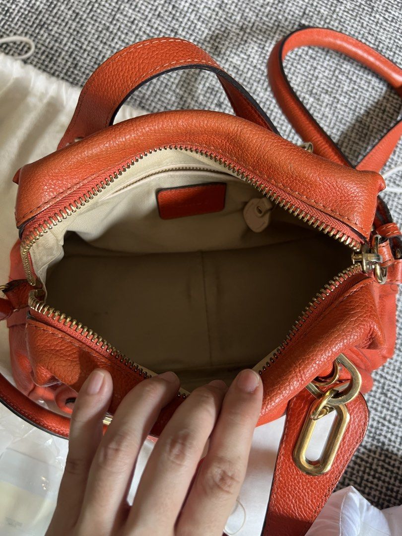 Chloe Paraty Small Bag (Category: Luxury Bags & Wallets) located in Manila. Submitted by declutteringmomma_ida (Listing ID 1433257058, Image 2). Description: - Authentic Chloe Paraty Small Bag - Vibrant orange color - Includes dust bag, authenticity cards, and tag - Top handle and shoulder strap - Gold-tone hardware - Zip closure - Multiple compartments - Minimal pen marks in interior.