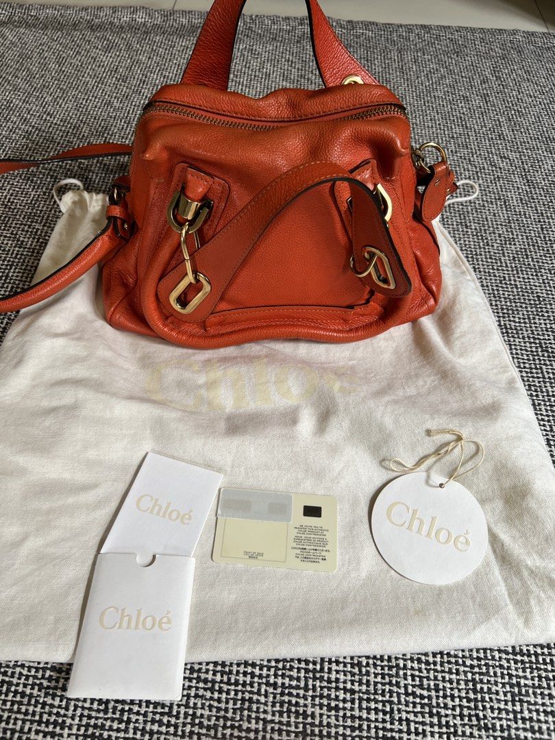 Chloe Paraty Small Bag (Category: Luxury Bags & Wallets) located in Manila. Submitted by declutteringmomma_ida (Listing ID 1433257058, Image 1). Description: - Authentic Chloe Paraty Small Bag - Vibrant orange color - Includes dust bag, authenticity cards, and tag - Top handle and shoulder strap - Gold-tone hardware - Zip closure - Multiple compartments - Minimal pen marks in interior.