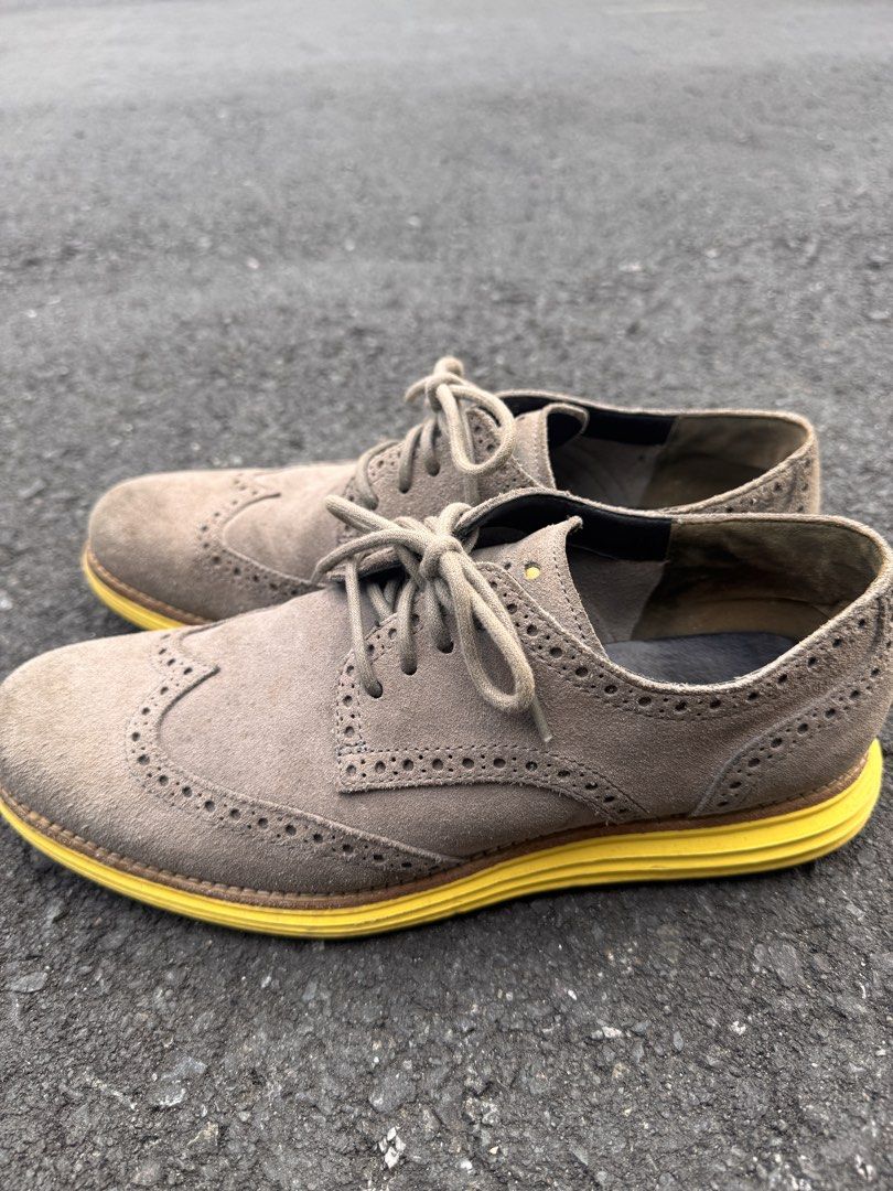Cole Haan Wingtip Oxford Shoes (Category: Dress Shoes) located in Quezon City. Submitted by ldrinquiry (Listing ID 1433294994, Image 1). Description: Cole Haan wingtip oxford shoes with a suede upper and yellow soles. The shoes feature a lace-up closure and the Cole Haan logo is visible on the insole. The shoes have a classic wingtip design with decorative perforations. The soles show some wear..