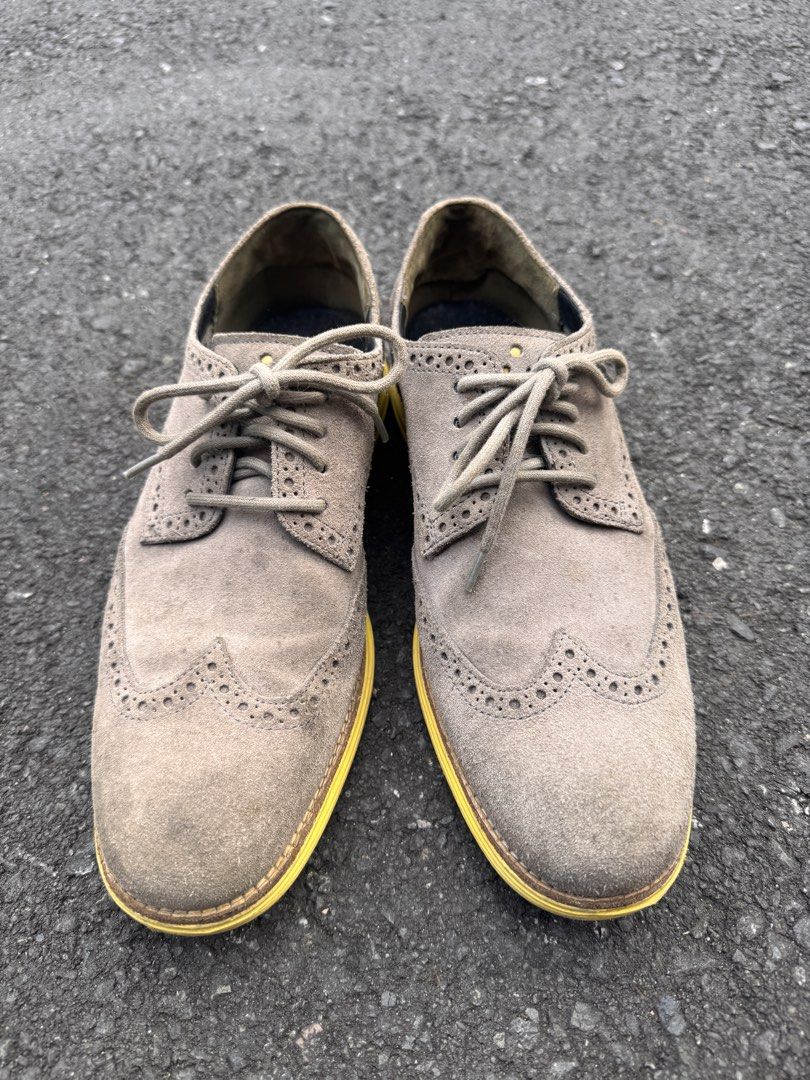 Cole Haan Wingtip Oxford Shoes (Category: Dress Shoes) located in Quezon City. Submitted by ldrinquiry (Listing ID 1433294994, Image 2). Description: Cole Haan wingtip oxford shoes with a suede upper and yellow soles. The shoes feature a lace-up closure and the Cole Haan logo is visible on the insole. The shoes have a classic wingtip design with decorative perforations. The soles show some wear..