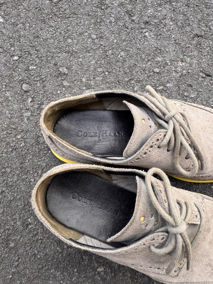 Cole Haan Wingtip Oxford Shoes (Category: Dress Shoes) located in Quezon City. Submitted by ldrinquiry (Listing ID 1433294994, Image 3). Description: Cole Haan wingtip oxford shoes with a suede upper and yellow soles. The shoes feature a lace-up closure and the Cole Haan logo is visible on the insole. The shoes have a classic wingtip design with decorative perforations. The soles show some wear..