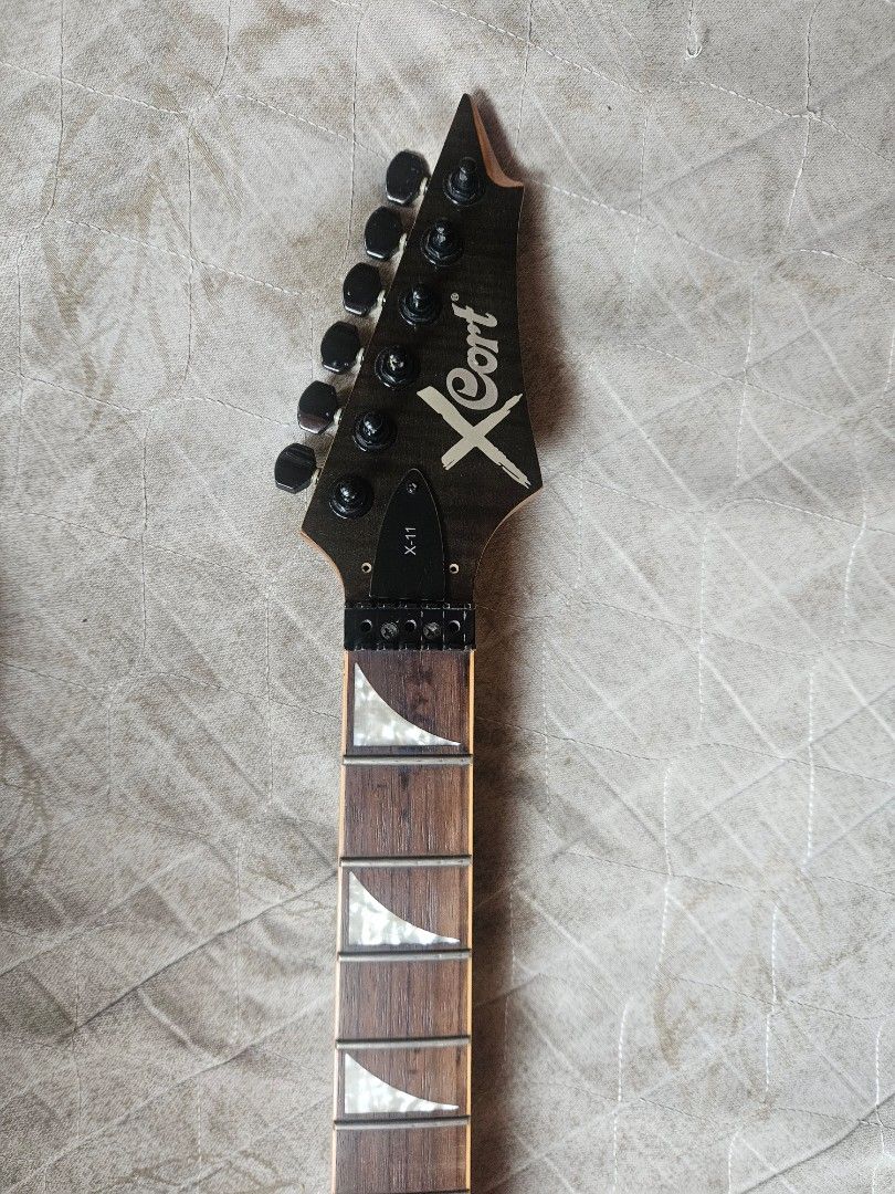 Cort X-11 Electric Guitar (Category: Musical Instruments) located in Pasay City. Submitted by cl_4711 (Listing ID 1433213956, Image 2). Description: - Cort X-11 electric guitar - Black finish - Double-cutaway body - Headstock with six tuners - Fretboard with triangular inlays - Two humbucker pickups + single coil - No Tremolo bridge - Original US Made Tremol-no included. Looks Brand New still Great Overall Body Condition, Perfect for Project Guit