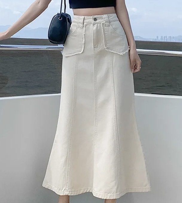 Cream Denim Skirt (Category: Skirts) located in Marikina City. Submitted by mfdecluttering (Listing ID 1433284797, Image 1). Description: - Cream-colored denim mermaid skirt - High-waisted design - Midi length - Front pockets - Button closure - Fitted silhouette through hips - Flared hem - Classic five-pocket design - Visible stitching details.