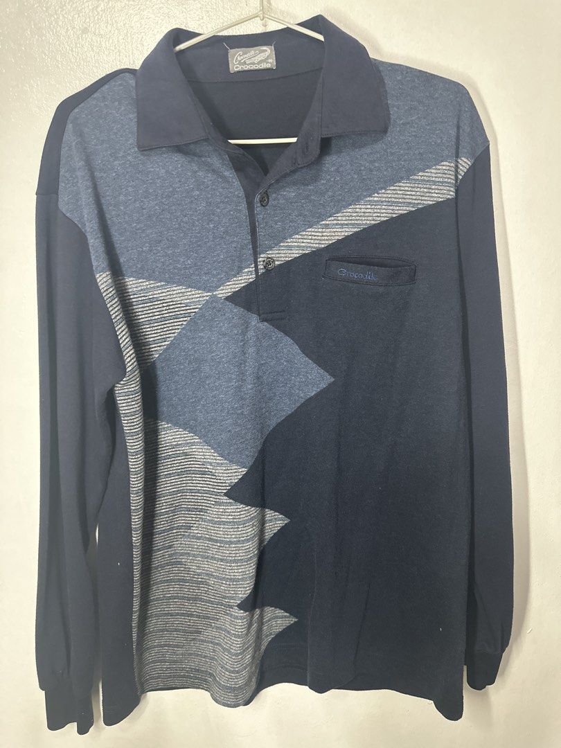 Crocodile Long Sleeve Polo Shirt (Category: Tshirts & Polo Shirts ) located in Batangas. Submitted by jim2621 (Listing ID 1433228826, Image 1). Description: - Long-sleeved polo shirt - Unique geometric blue design - Classic polo collar - Chest pocket with Crocodile logo - Crocodile logo buttons - Ribbed cuffs - Comfortable fabric.
