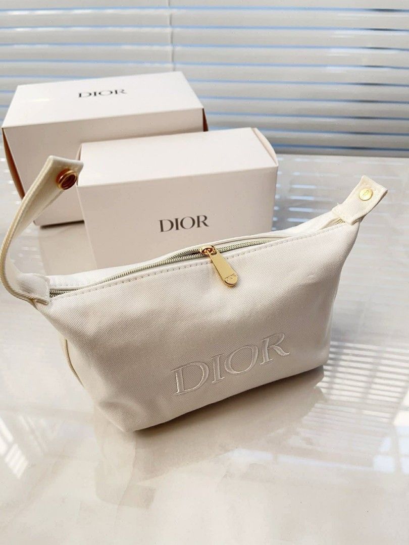 Dior Cosmetic Pouch (Category: Luxury Bags & Wallets) located in Manila. Submitted by nicethingsandstuff (Listing ID 1433213852, Image 1). Description: - Authentic Dior cosmetic pouch - White canvas exterior - Embroidered Dior logo - Gold-tone zipper - Convenient handle - Comes with original box - Ideal for storing makeup.