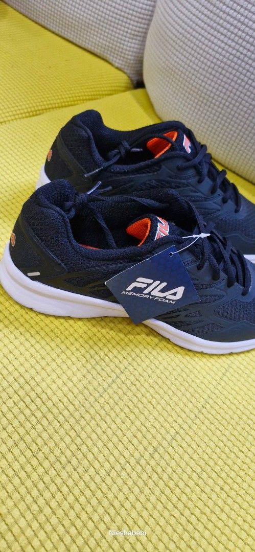Fila Shoes for Men (Category: Sneakers) located in Paranaque City. Submitted by nieshaprelovedshop (Listing ID 1433386322, Image 2). Description: - Fila running shoes - Color: Navy blue with white soles and orange accents - Size: US 10, EUR 43, UK 9, MEX 28 - Features: Mesh upper - Condition: New with tags.