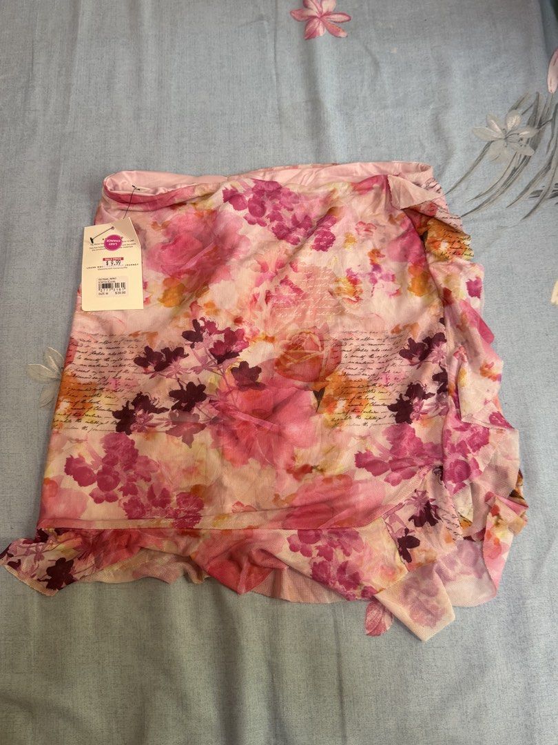 Glassons Floral Wrap Skirt (Category: Skirts) located in Cebu City. Submitted by hellomolly_ (Listing ID 1433346750, Image 1). Description: - Glassons wrap skirt - Size: M - Floral print - Ruffled hem - Lightweight fabric - Colors: Pink, red, white - Perfect for beach and fairycore aesthetic.