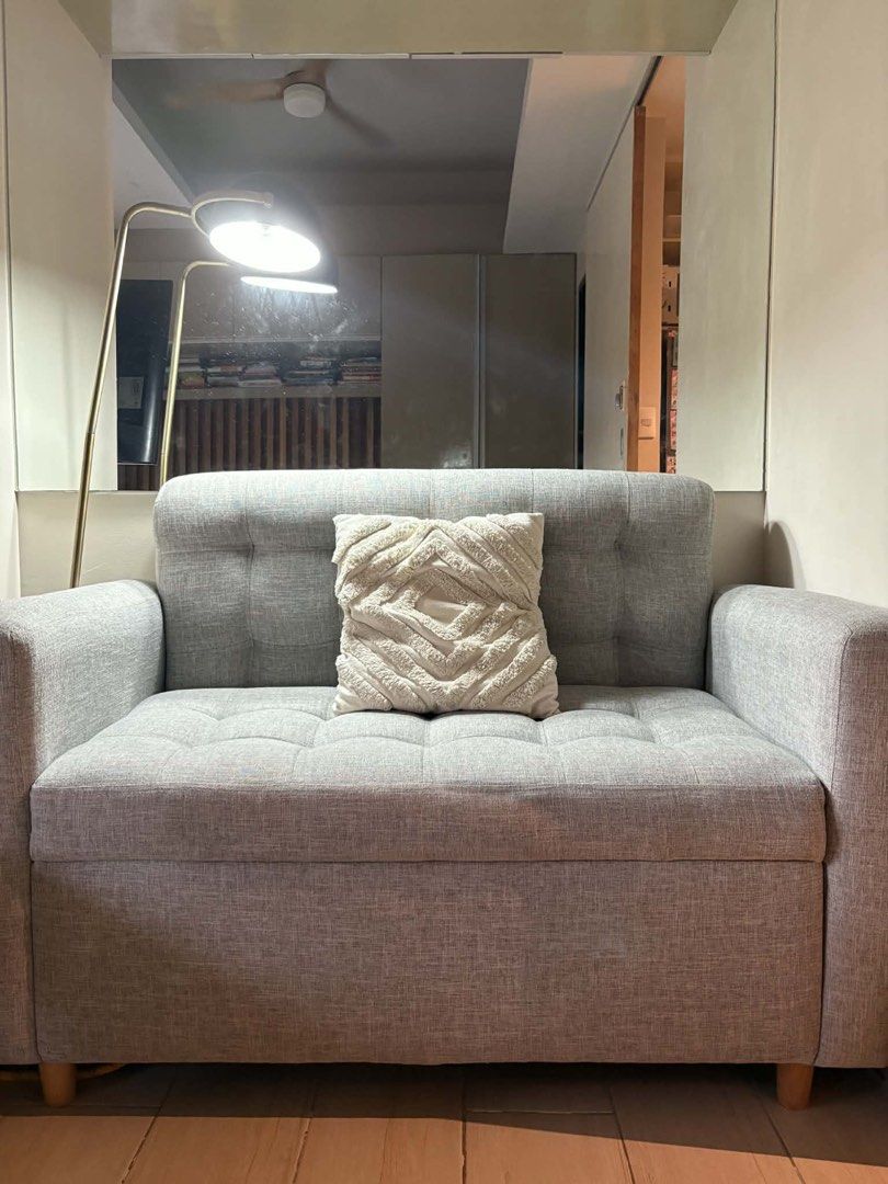 Gray 2-Seater Sofa with Storage (Category: Sofas) located in Makati City. Submitted by jamfab11 (Listing ID 1433306410, Image 2). Description: H 34 inches L 50 inches W 27 inches Stylish gray 2-seater sofa - Tufted back and seat cushions - Comfortable armrests - Sturdy wooden legs - Hidden storage compartment under the seat - Pillow not included - Perfect for small apartments or living rooms.