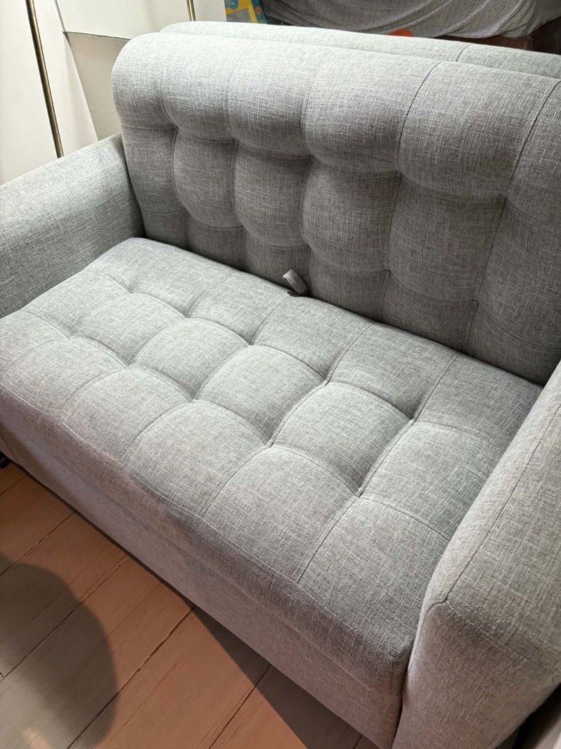 Gray 2-Seater Sofa with Storage (Category: Sofas) located in Makati City. Submitted by jamfab11 (Listing ID 1433306410, Image 1). Description: H 34 inches L 50 inches W 27 inches Stylish gray 2-seater sofa - Tufted back and seat cushions - Comfortable armrests - Sturdy wooden legs - Hidden storage compartment under the seat - Pillow not included - Perfect for small apartments or living rooms.