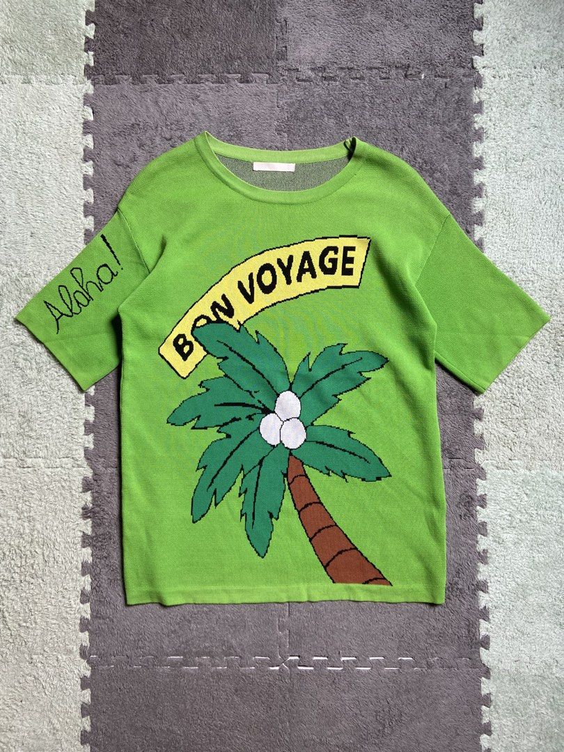 Green Palm Tree Graphic T-shirt (Category: Tshirts & Polo Shirts ) located in Antipolo. Submitted by casmiro (Listing ID 1433318205, Image 1). Description: - Green t-shirt - Features a 'Bon Voyage' palm tree graphic - 'Aloha!' detail on the sleeve - Round neckline - Short sleeves - Made of knit fabric - Perfect for a tropical look!.