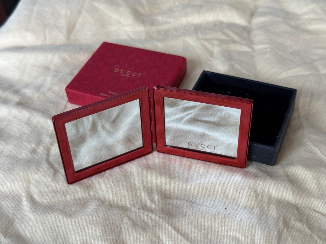 Gucci Beauty Pocket Mirror (Category: Face Care) located in Bustos. Submitted by theprelovedshopbulacan (Listing ID 1433218221, Image 3). Description: - Authentic Gucci Beauty pocket mirror - Red color - Square shape - Embossed Gucci logo - Comes with original red box - Box features Gucci Beauty logo - Opens to reveal two mirrors.